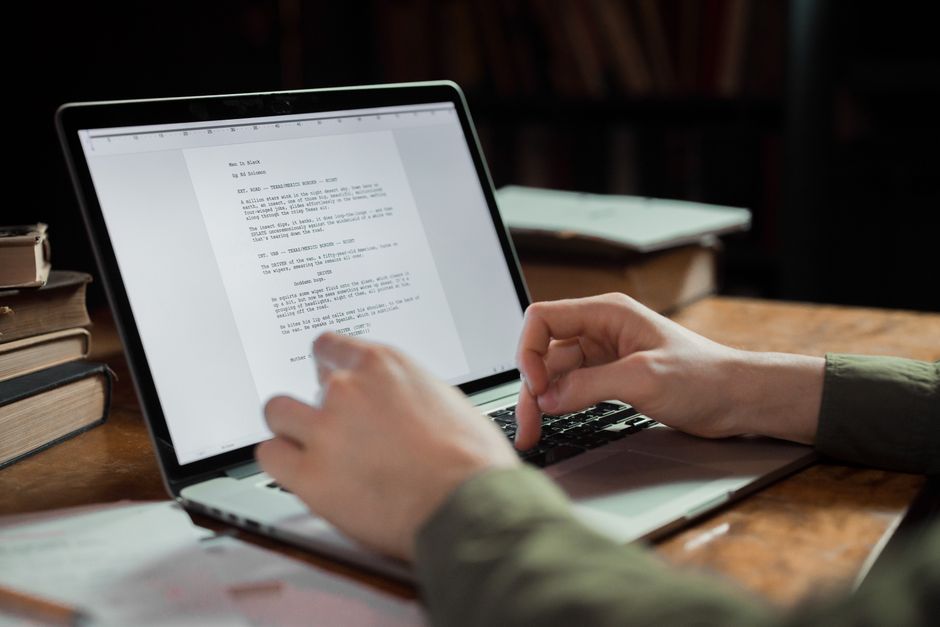 Writer editing a draft on a laptop, representing refining AI-assisted content